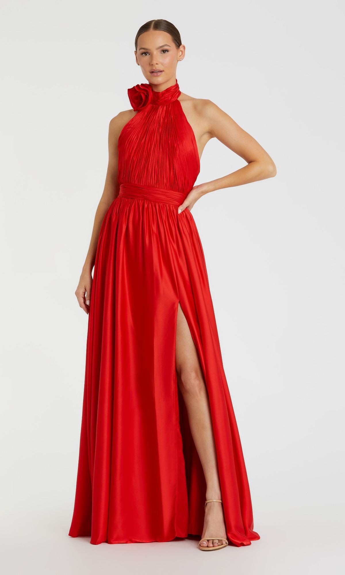 Woman in a High-Neck Halter Formal Dress: Mac Duggal 49333, a sleeveless, floor-length red gown with ruffled neckline, thigh-high slit, and open back, posing against a plain white background.
